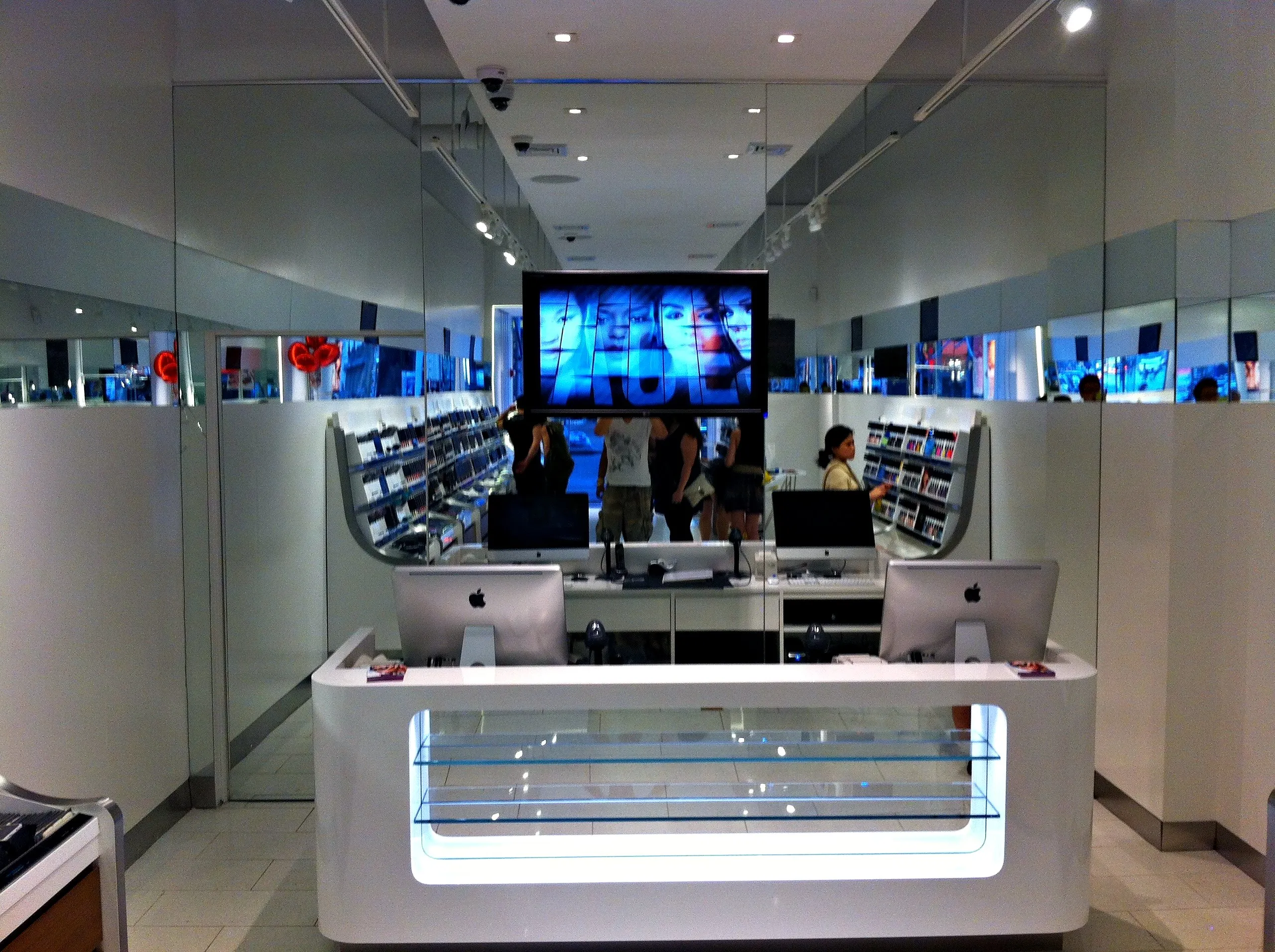Retail store with ceiling cameras and a display wall
